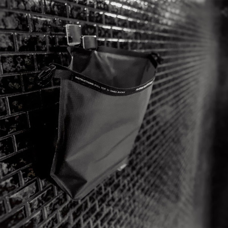Waterproof Toiletry Case hanging from black-tiled bathroom hook