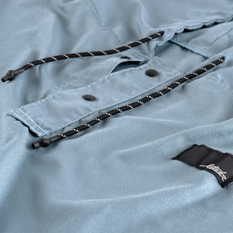 Close up view of drawstings and snaps of slate poncho