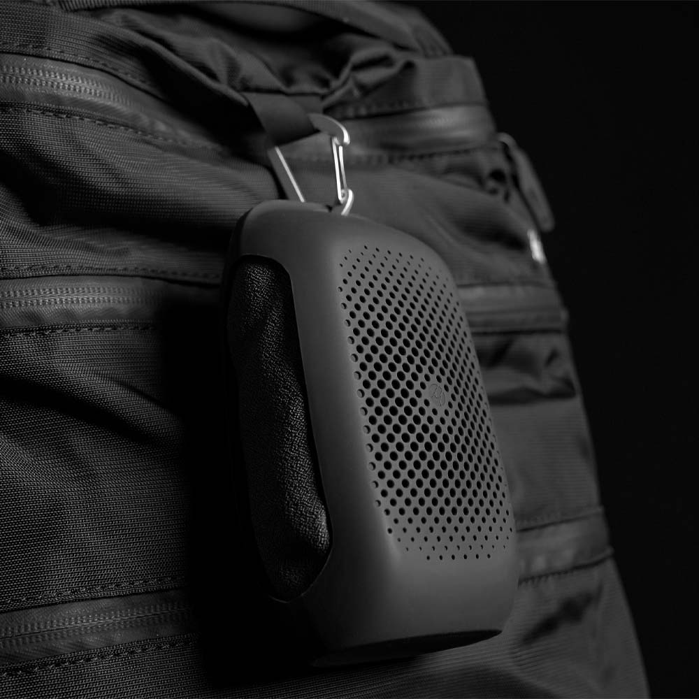 Charcoal NanoDry Towel hanging from backpack by carabiner