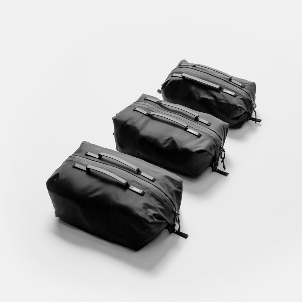 3 black gear cubes on light gray background