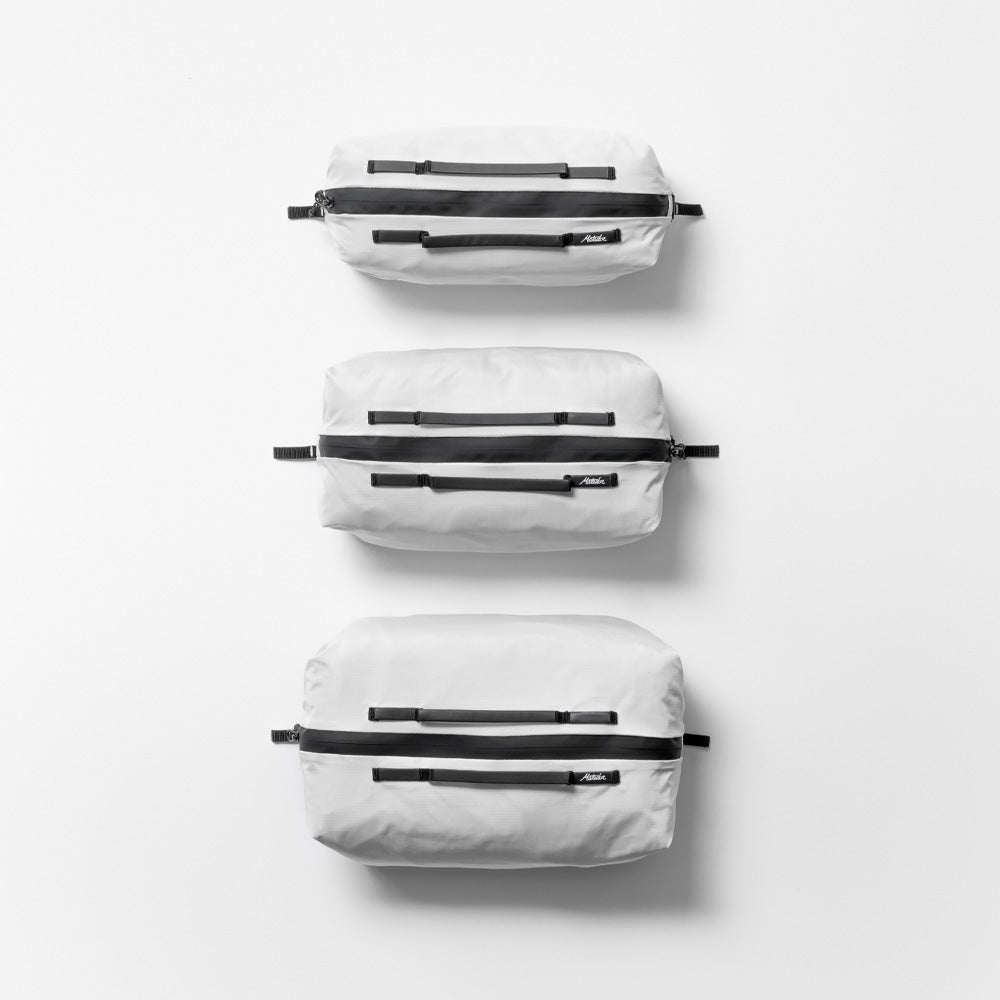 top view of 3 white gear cubes closed on light gray background