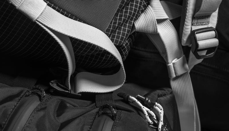 Close up view of various Matador bag materials piled together, including fabric, zippers, and hardware