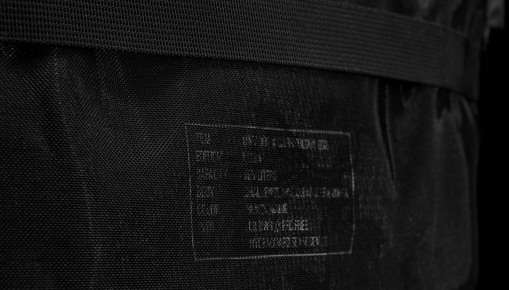 detail view of text behind mesh of messenger bag