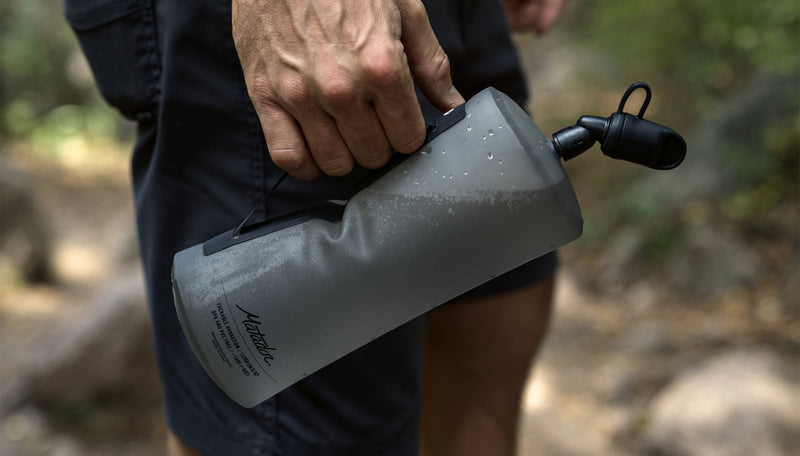 Man holding Packable Water Bottle by Hypalon handle