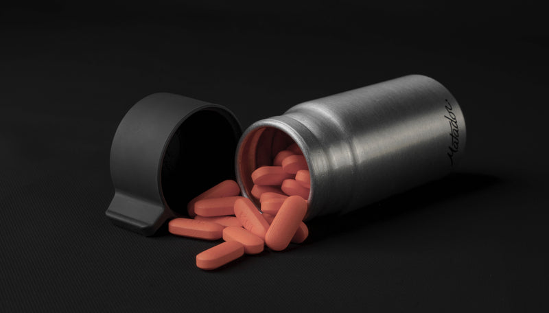 40ml canister on black background with red pills spilling out