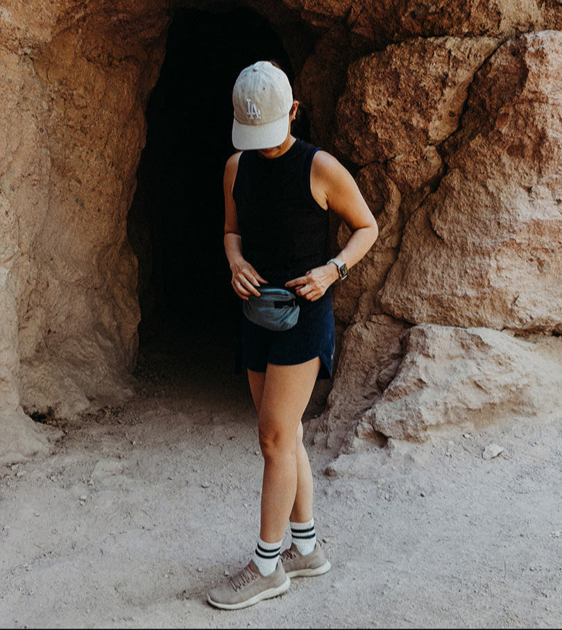 person outside with a hip sling enjoying a last-minute summer adventure