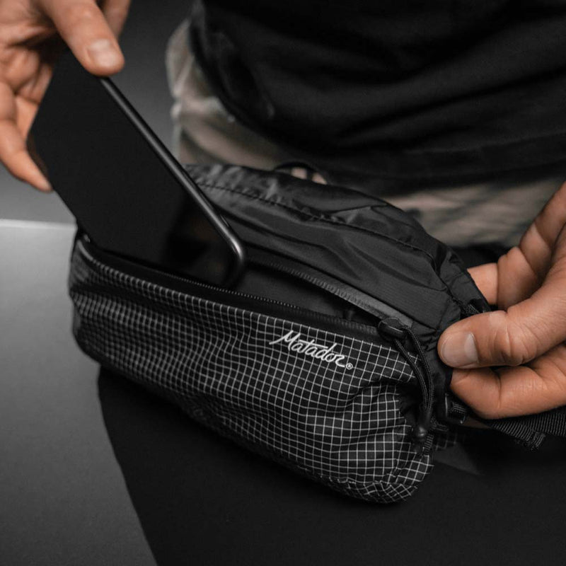 Placing cell phone in hip pack front pocket