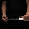 Man holding fully open pill slider on black background