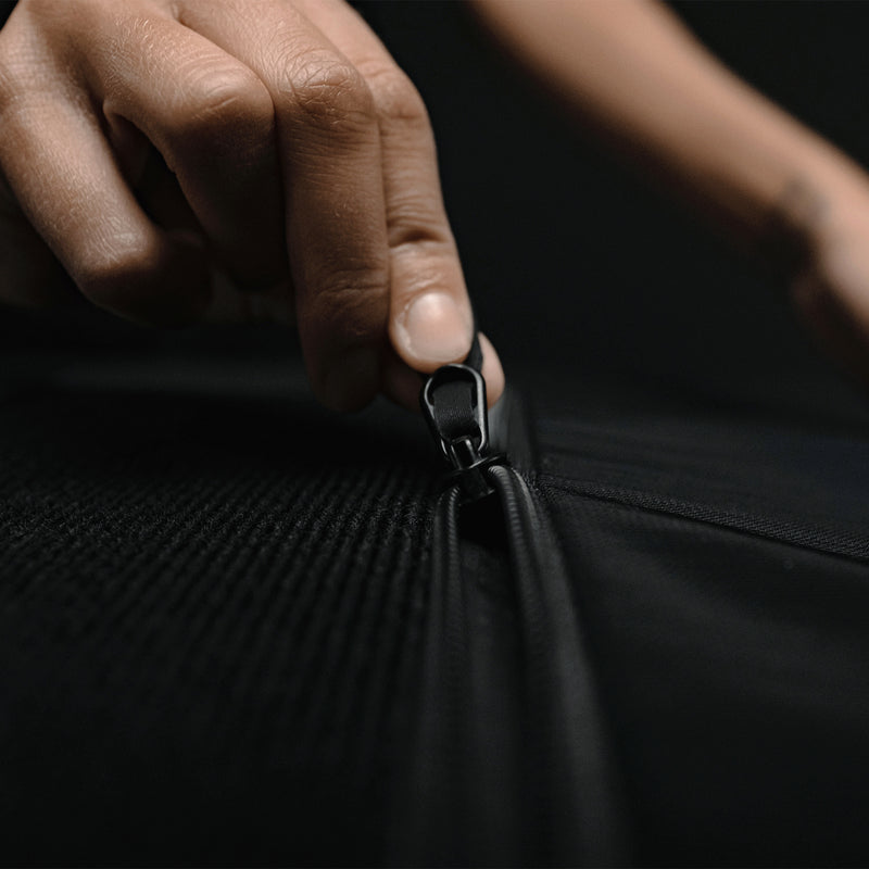 Close up view of fingers pulling open zipper pocket