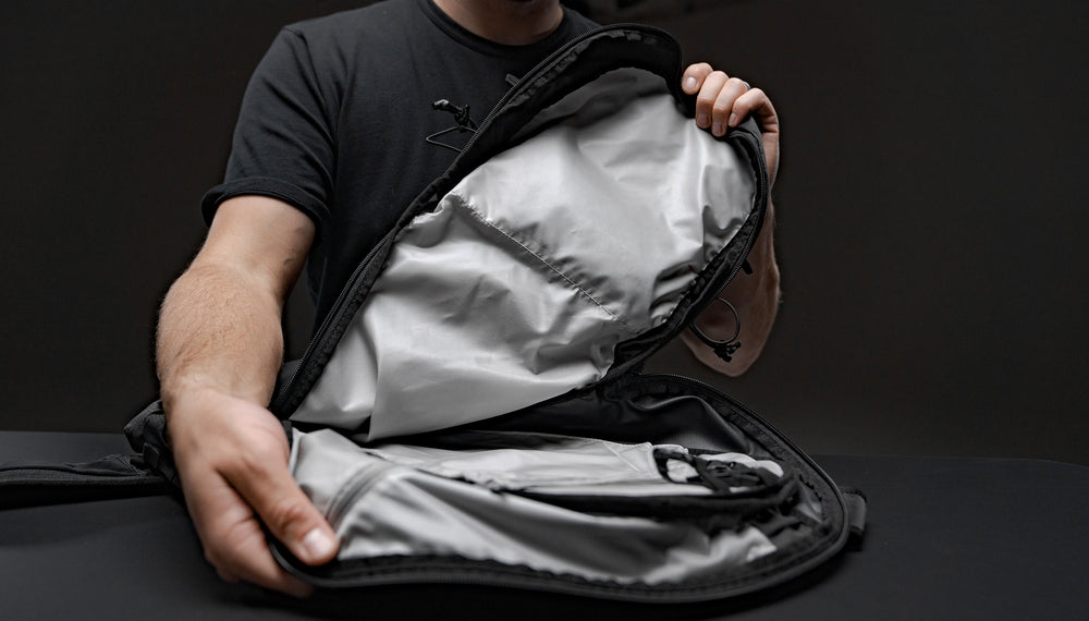 Man on black background holding beast18 pack open