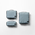 top view of slate small, medium, and large packing cubes on white background