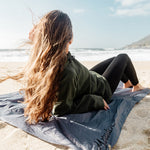 Woman laying on Pocket Blanket on sandy beach
