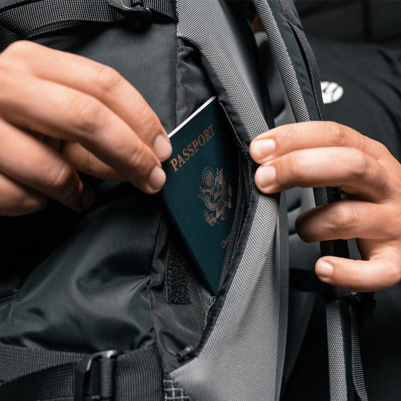 Close up view of passport being placed in smuggler's pocket