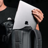 Close up view of Apple laptop being place in external laptop pocket of SEG28