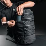 Man placing water bottle in SEG28 external water bottle pocket