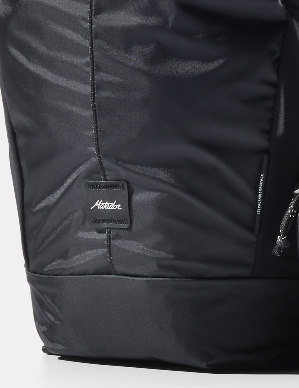 close up view of matador logo sewn onto black bag