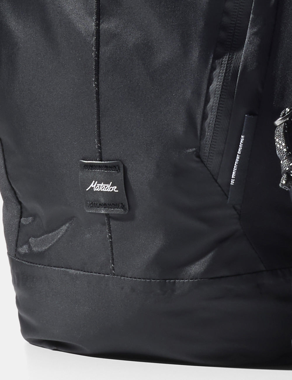 close up of matador logo sewn onto black bag