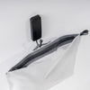 top view of white zipper toiletry case hanging from black hook
