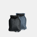 Black and Slate blue Flatpak soap bar cases on light gray background