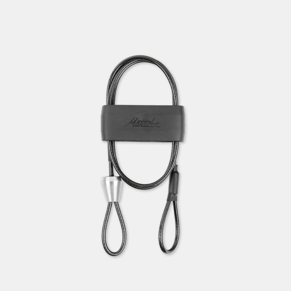 BetaLock Accessory Cable wrapped up, sitting on light gray background