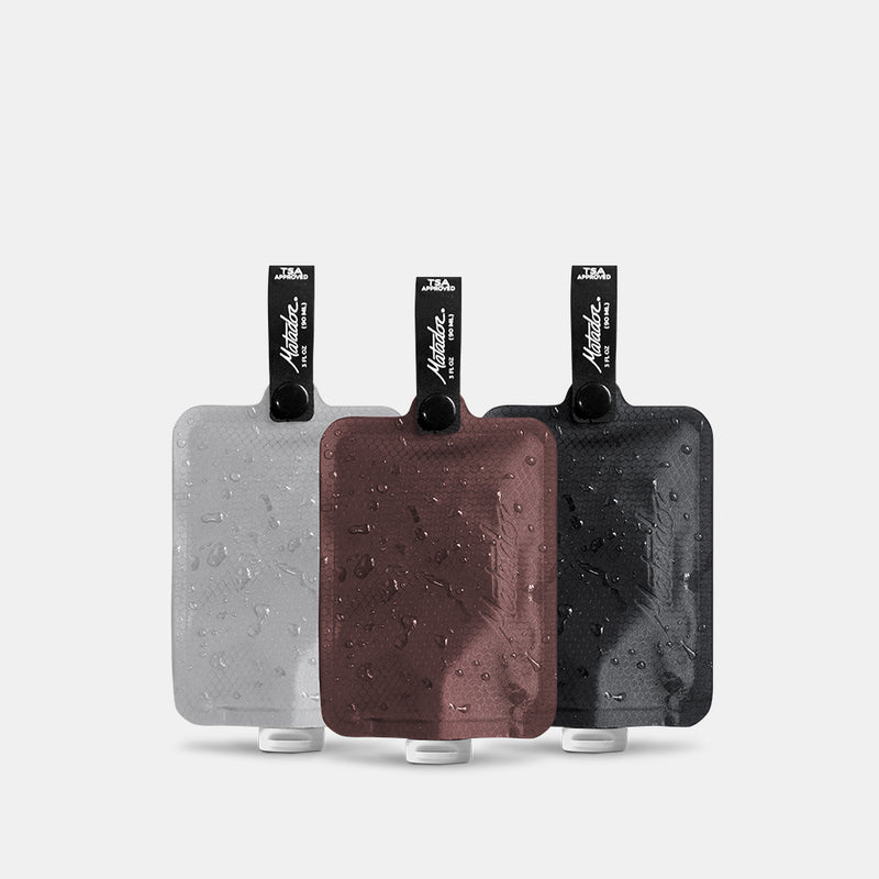 Toiletry bottle 3-pack multi2 charcoal garnet and arctic on light gray background