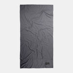 Top-down view of full charcoal towel on light gray background