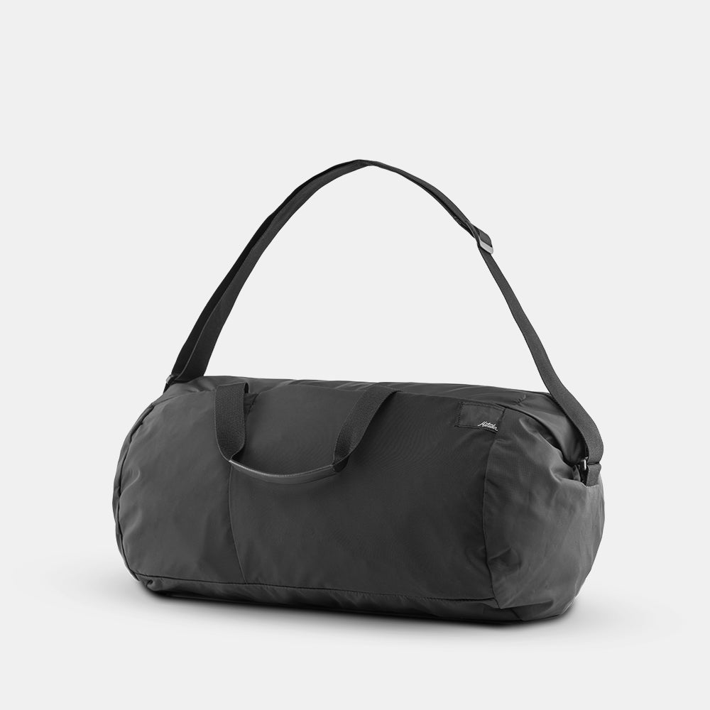 3/4 view of black duffle on light gray background