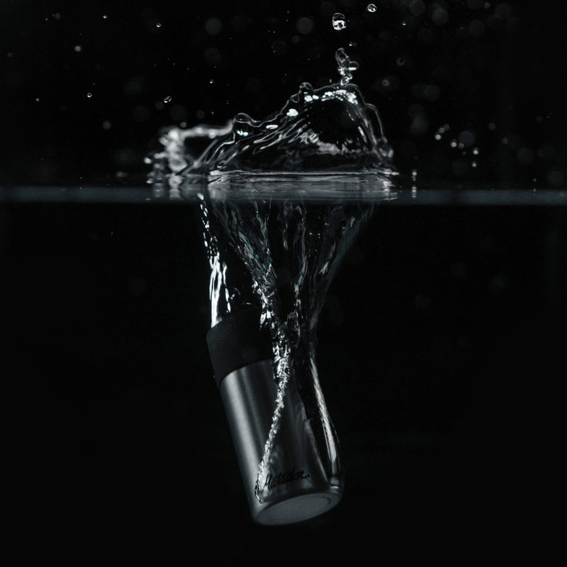 40mL canister splashing into water with black background