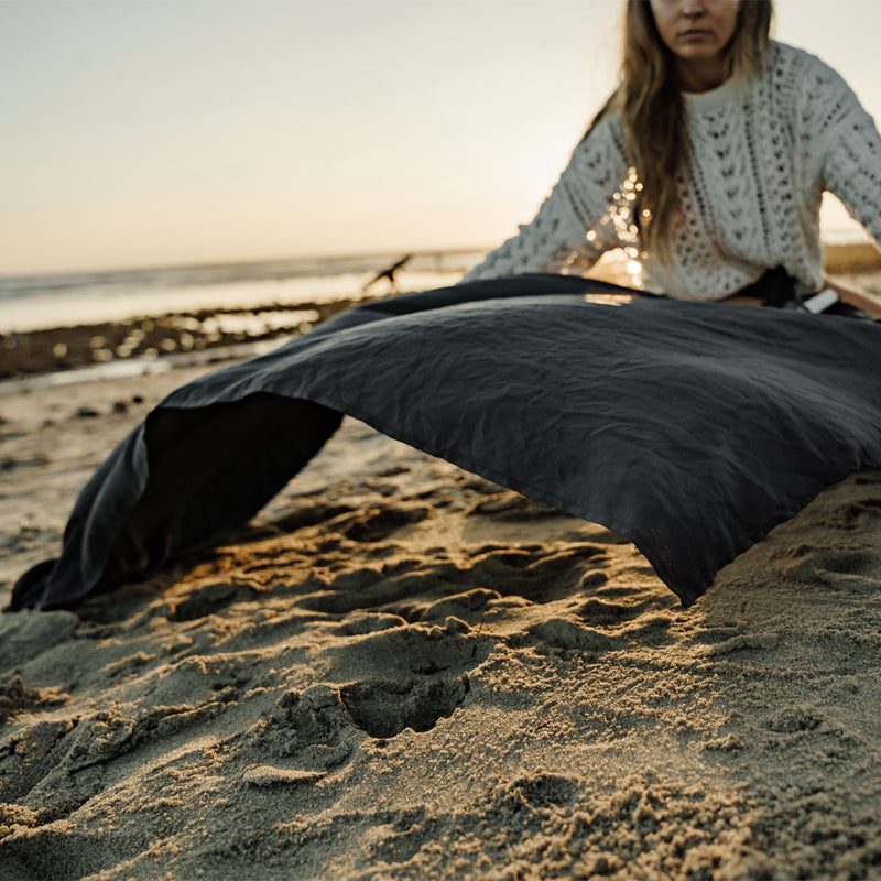Woman on beach, laying out beach towel
