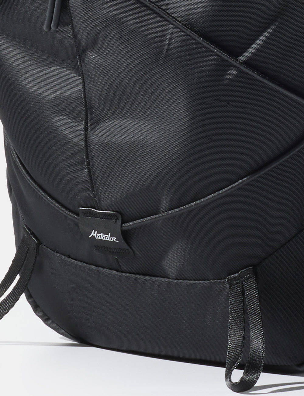 close up of matador logo sewn onto black bag