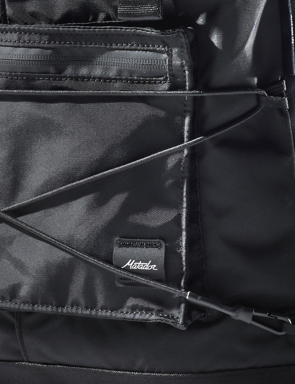 close up of matador logo sewn onto black bag