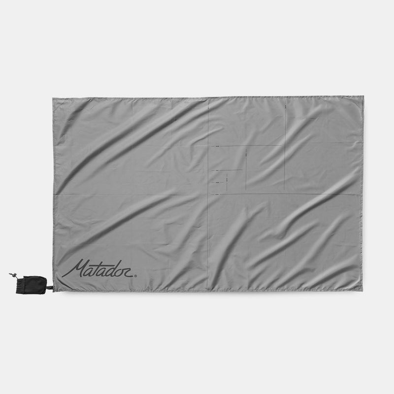 Pocket Blanket Mini laid flat on a light gray background