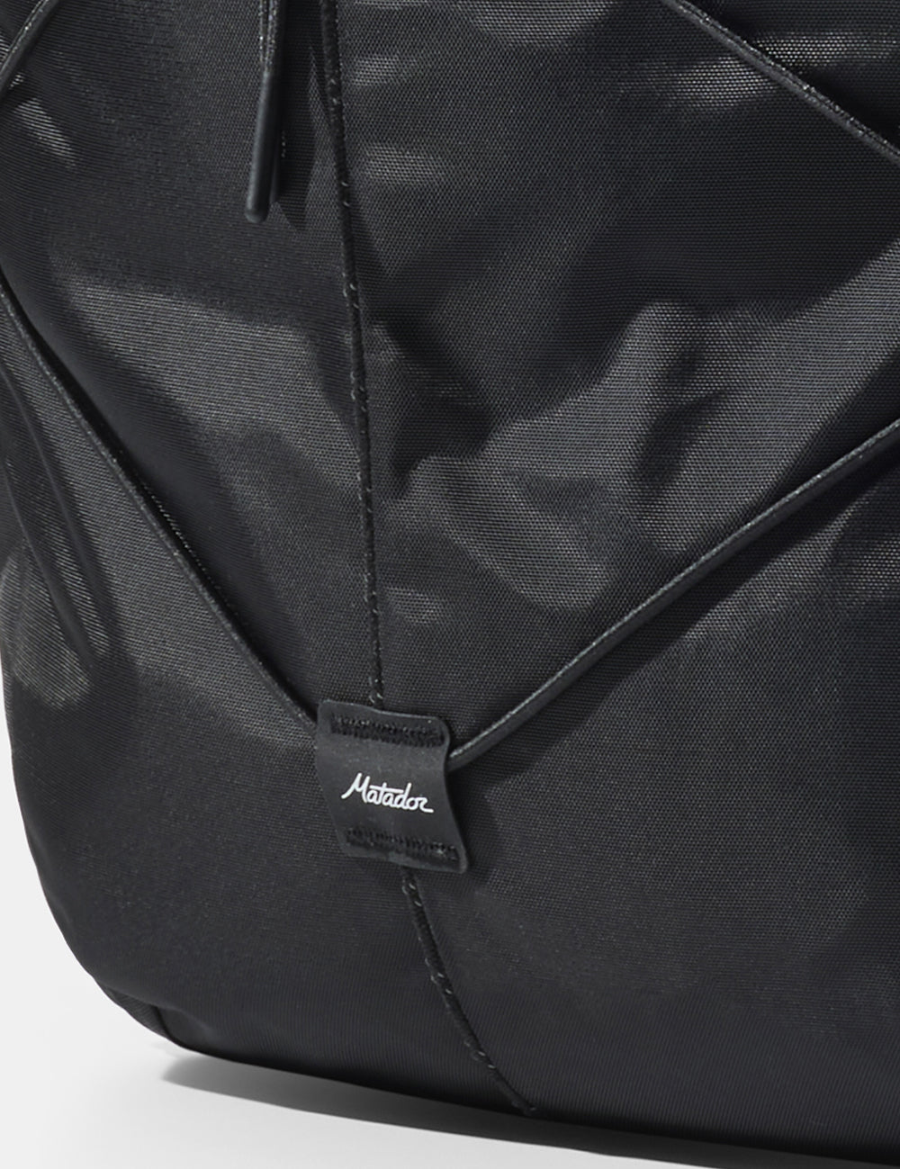 close up of matador logo sewn onto black bag