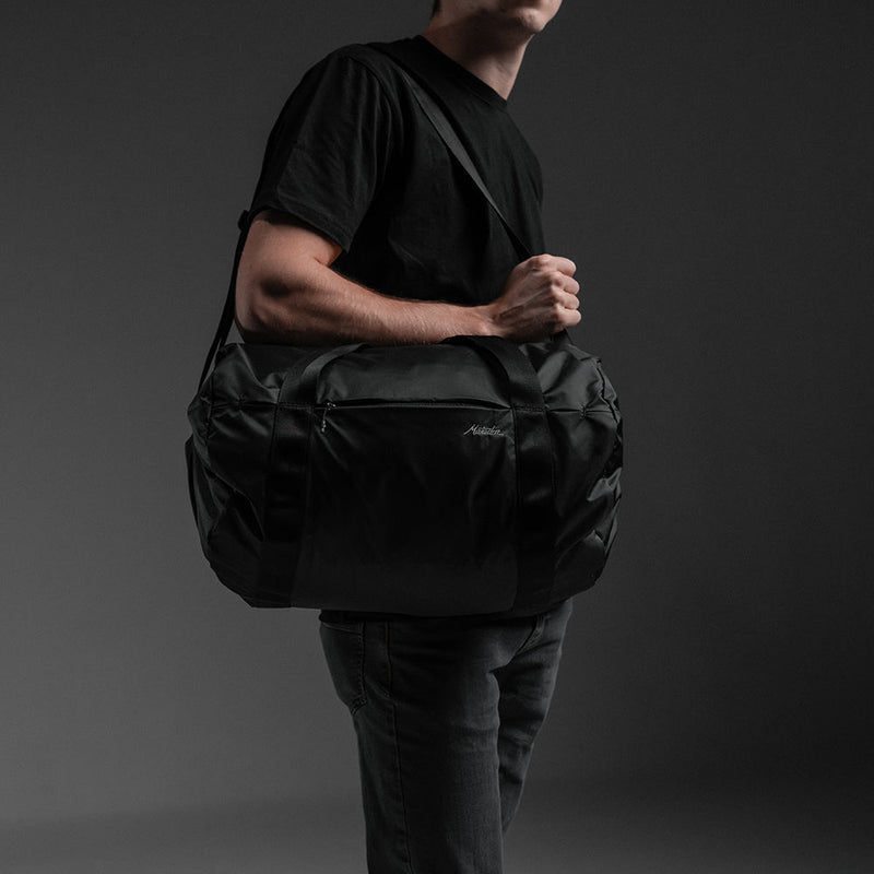Man on gray background wearing On-Grid Duffle
