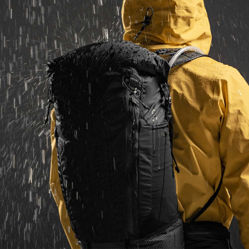 Person in yellow jacket wearing Freeerain28 in the rain