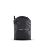 Packed up black duffle on white background