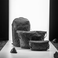 black backpack, messenger bag, and sling on light up white studio background