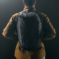 man in black studio wearing black backpack