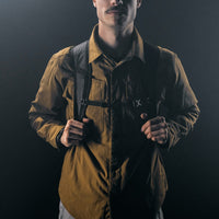 front view of sternum strap of black backpack