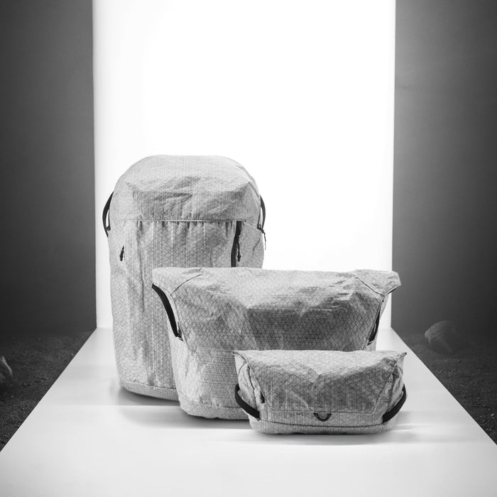 White backpack, messenger, and sling on a light up white background