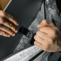 interior view of white messenger bag with laptop being placed in sleeve
