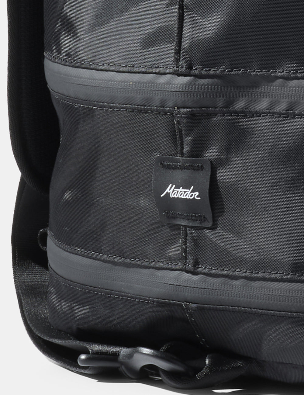 close up of matador logo sewn onto black bag
