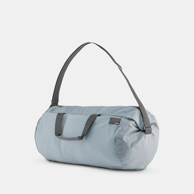 3/4 view of slate blue duffle on white background
