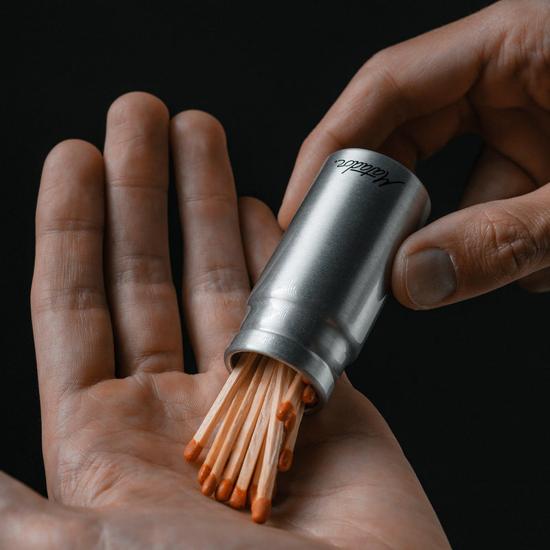 Hands pouring matches out of 40mL canister