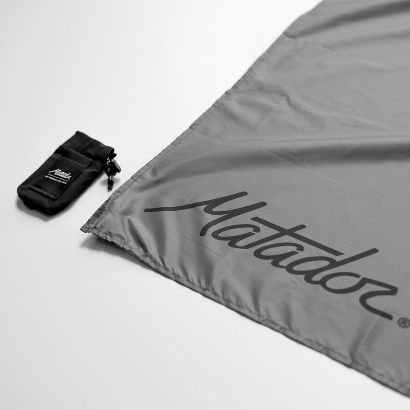 Black Pocket Blanket Mini storage bag detached from the pocket blanket