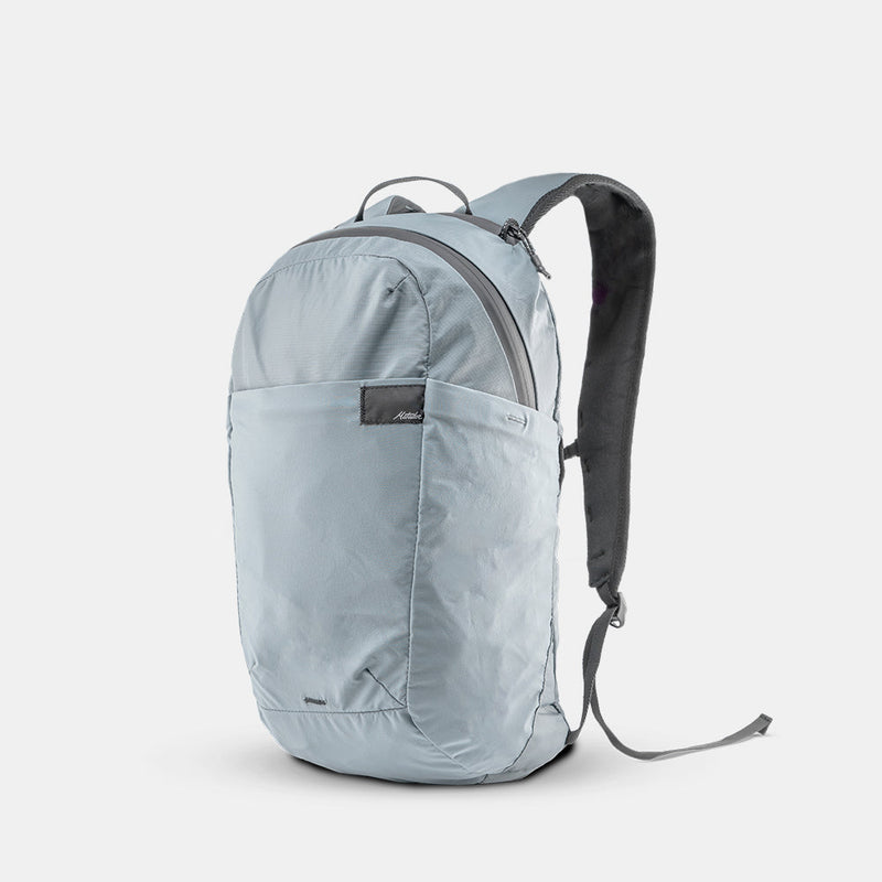 3/4 view of slate blue backpack on light gray background