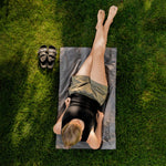 Top view of woman laying on Pocket Blanket Mini on shady green grash