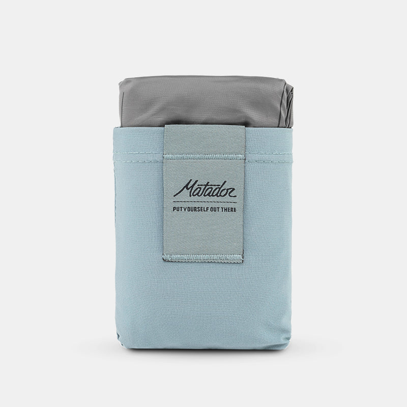Slate blue Pocket Blanket on light gray background