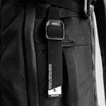 black gear tag hanging off black backpack loop