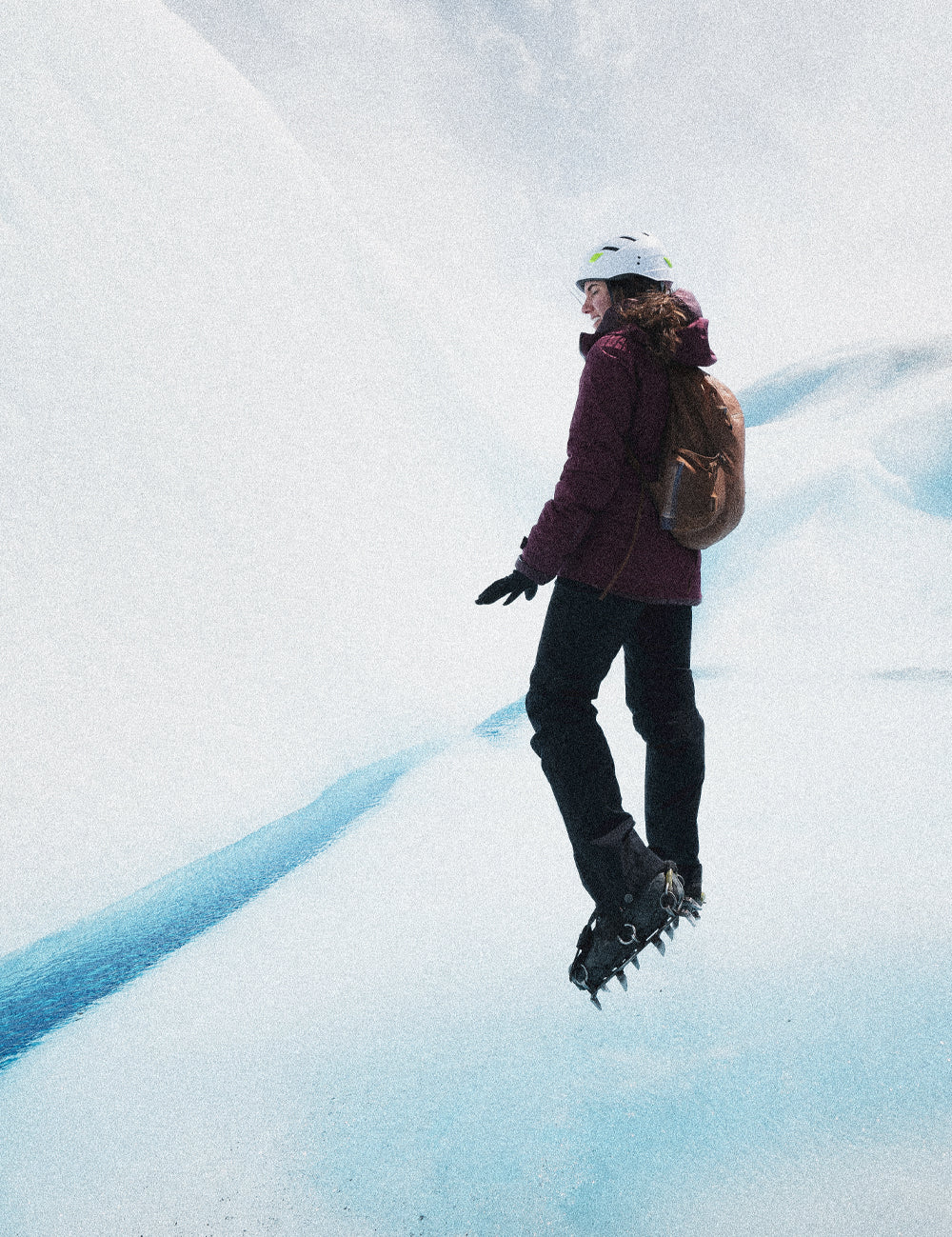 person standing on pristine glacier with crampon shoes
